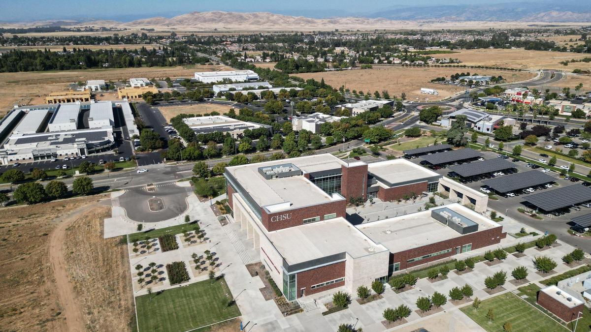 The California Health Sciences University College of Osteopathic Medicine building in Clovis’ Research and Technology Park is at center while other buildings and empty lots that could be used for potential housing stand in the distance in the drone image made on Wednesday, Sept. 27, 2023.