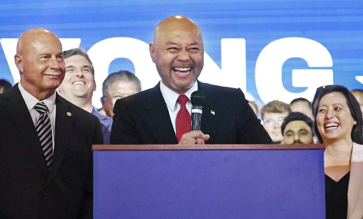 Clovis Mayor Vong Mouanoutoua, center, laughs as he announces the launch of his campaign for Fresno County Board of Supervisors District 5 during an event at the Regency Event Center Friday, June 12, 2026 in Clovis.
