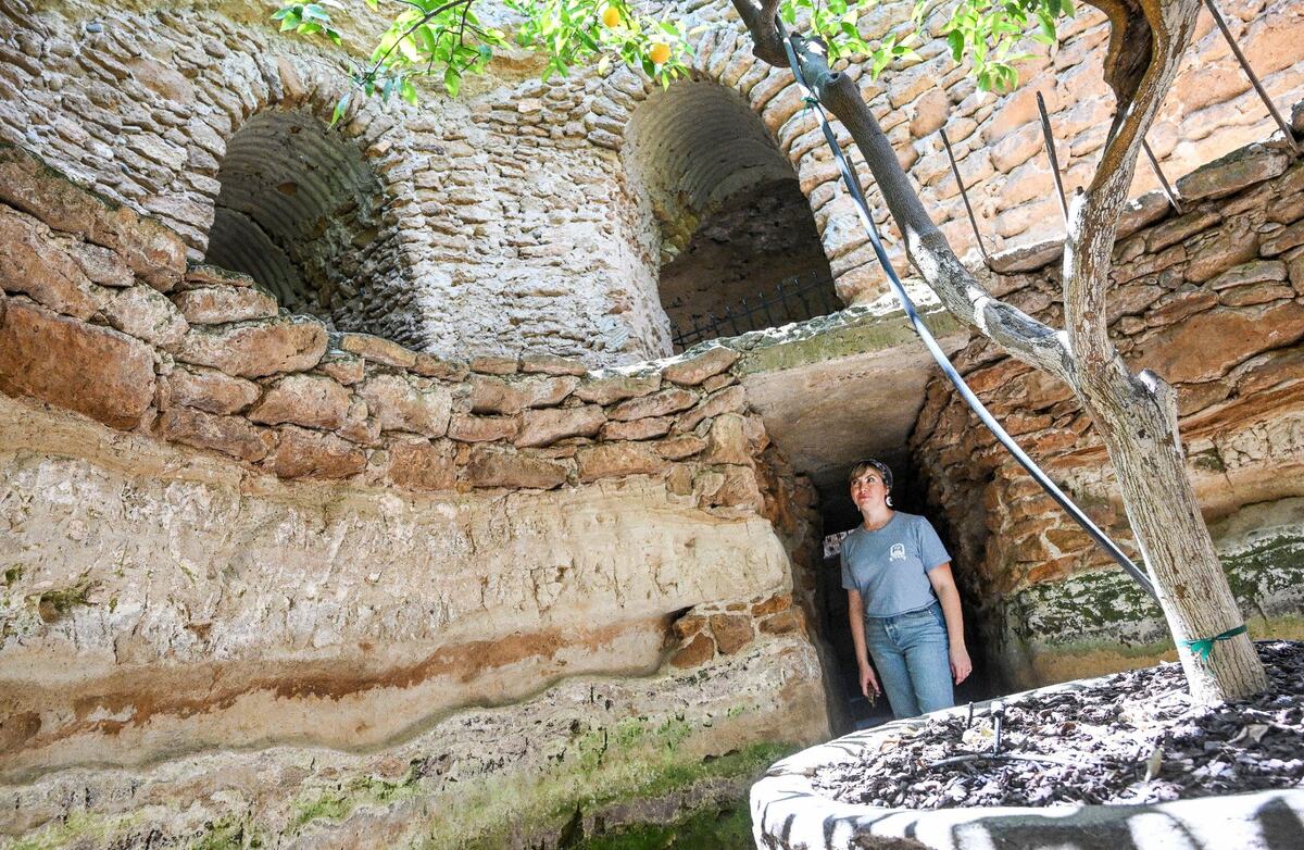 Shera Franzman, director of operations at the Forestiere Underground Gardens in Fresno, stands in a deep section of cavernous tunnels built in the early 20th century by Sicilian immigrant Baldassare Forestiere with trees he planted over 100 years old that still produce fruit.
