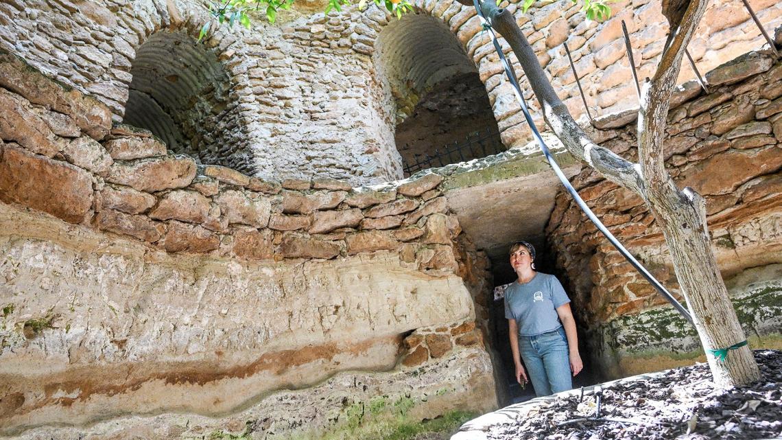 Shera Franzman, director of operations at the Forestiere Underground Gardens in Fresno, stands in a deep section of cavernous tunnels built in the early 20th century by Sicilian immigrant Baldassare Forestiere with trees he planted over 100 years old that still produce fruit.