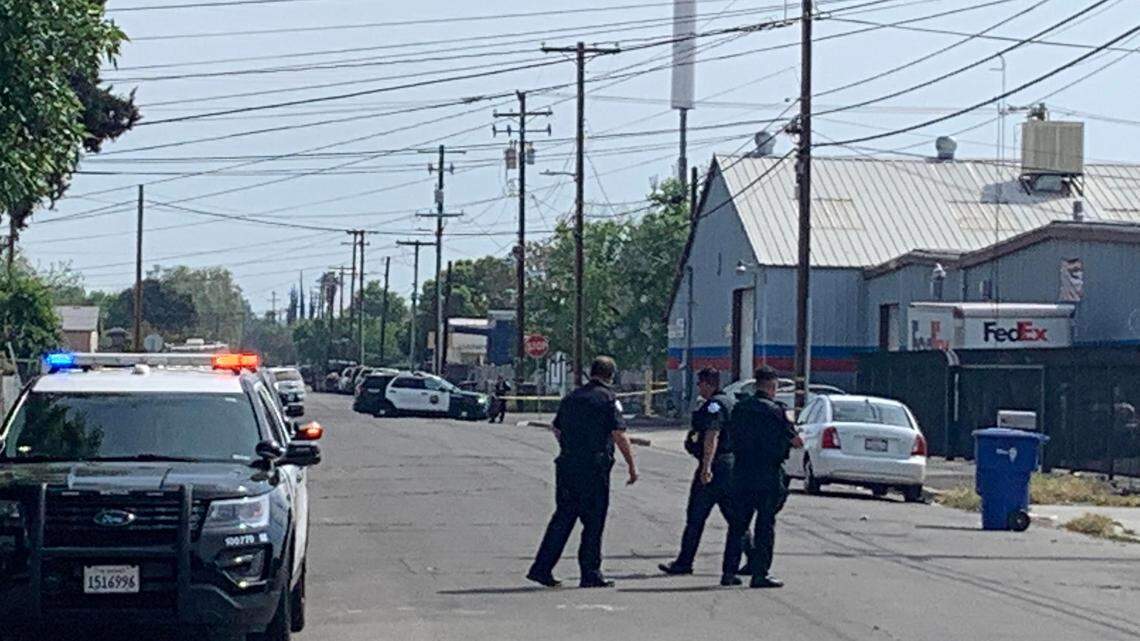 Fresno police officers investigate stabbings that injured two men Saturday morning, March 26, 2022, near Belmont and Maple avenues.