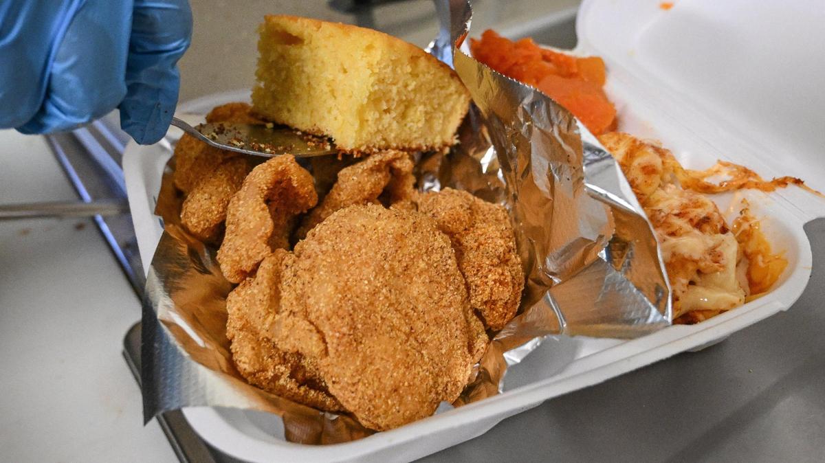 A fried catfish combo meal is boxed up with yams, mac & cheese and cornbread at Doll’s Kitchen which recently opened up in the shopping center southwest of the intersection of Shaw and Blackstone in Fresno.