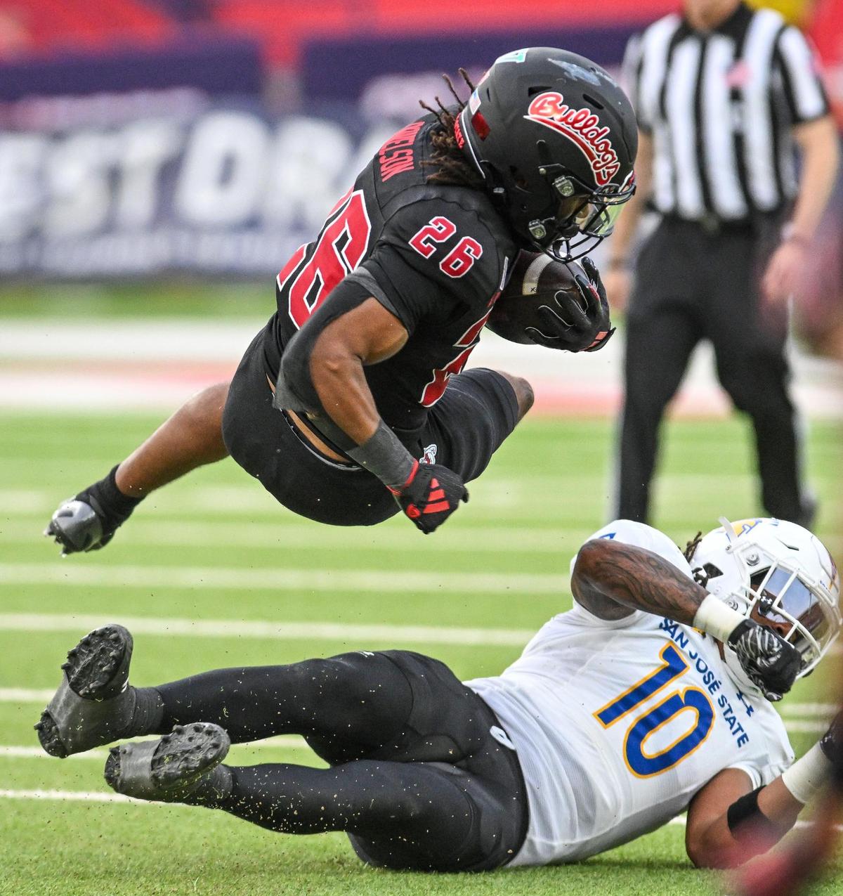 Fresno State’s Bryson Donelson flies over San José State’s Jordan Pollard on a run during their game at Valley Children’s Stadium in Fresno on Saturday, Oct. 26, 2024.