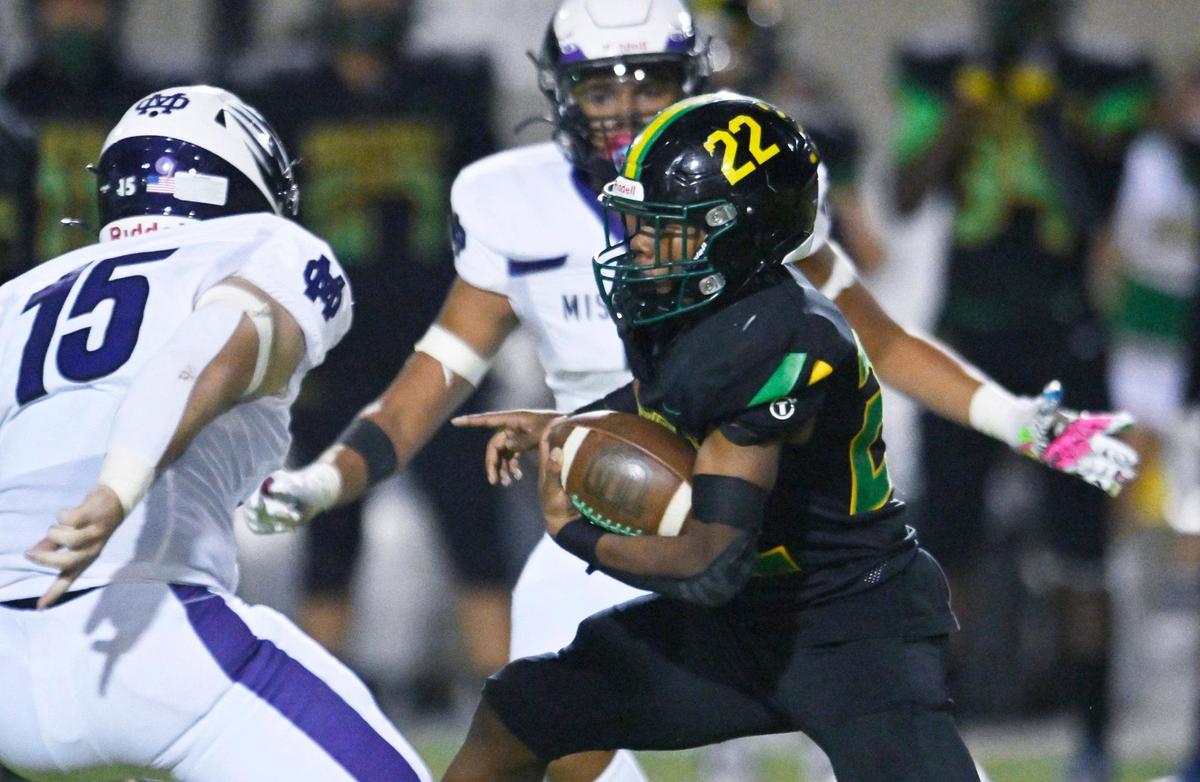 Roosevelt’s Dimareea Banks, right, finds an opening in the Mission Oak defense Friday, Sept. 1, 2023 in Fresno. Mission Oak won, 31-7.