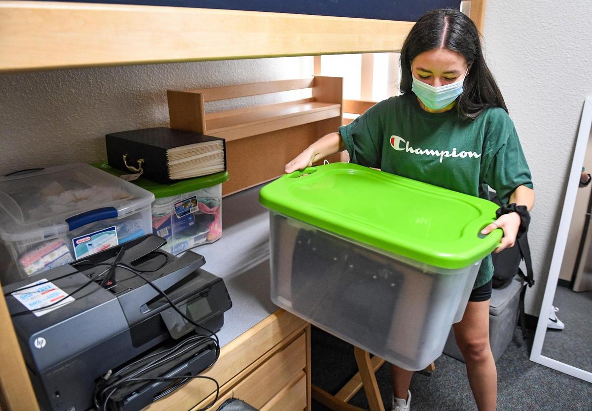 Pre-med student Paulina Medina unpacks her belongings in her new dorm room at Aspen Hall in the on-campus housing area at Fresno State on Thursday, Aug. 19, 2021.