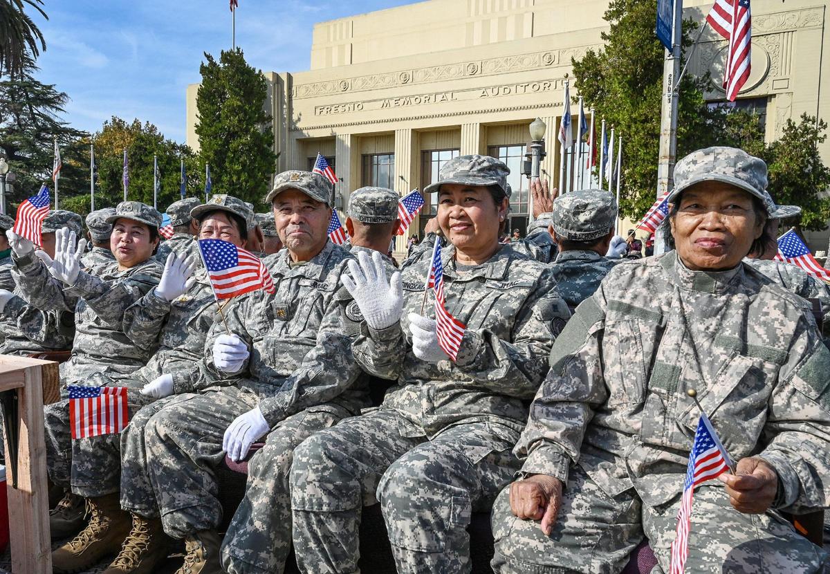 Hmong veterans ride on a Joint Military Assistance Command float in front of the Fresno Memorial Auditorium during the annual Veterans Parade in downtown Fresno on Friday, Nov. 11, 2022.