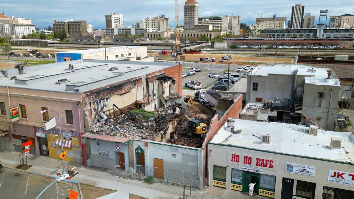 Demolition continues on the Bow On Tong Association building, center, as part of the City of Fresno restoration plan in Chinatown, with the downtown skyline in the background Tuesday, April 1, 2025 in Fresno.