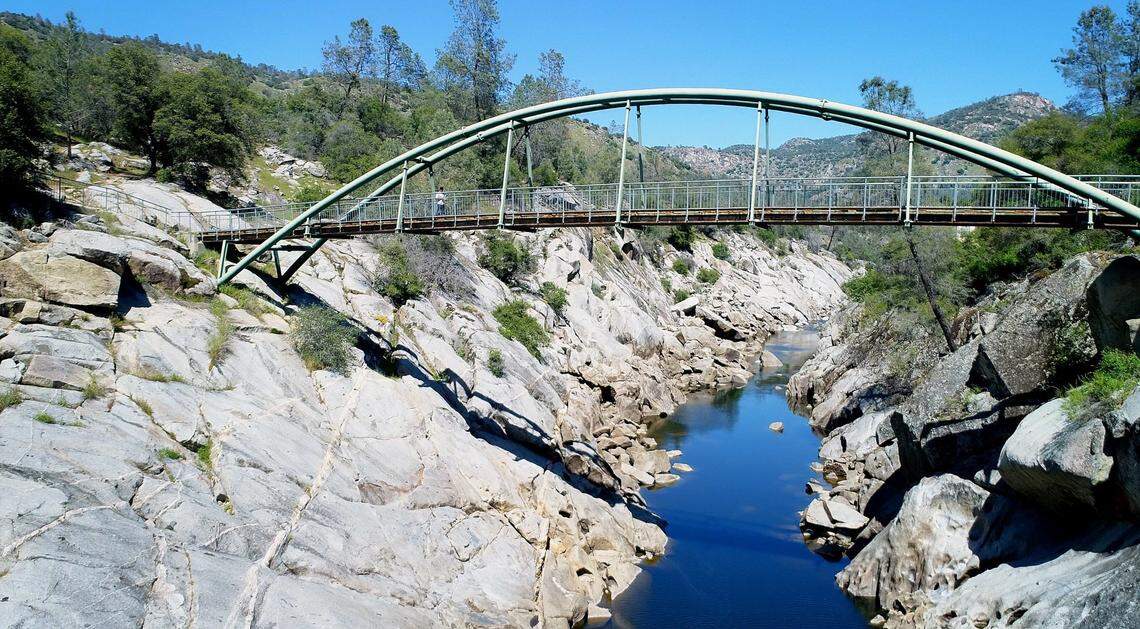 The footbridge that crosses the San Joaquin River at the San Joaquin River Gorge Special Recreation Management Area near Auberry is seen in this aerial image taken by drone on Friday, April 20, 2018.