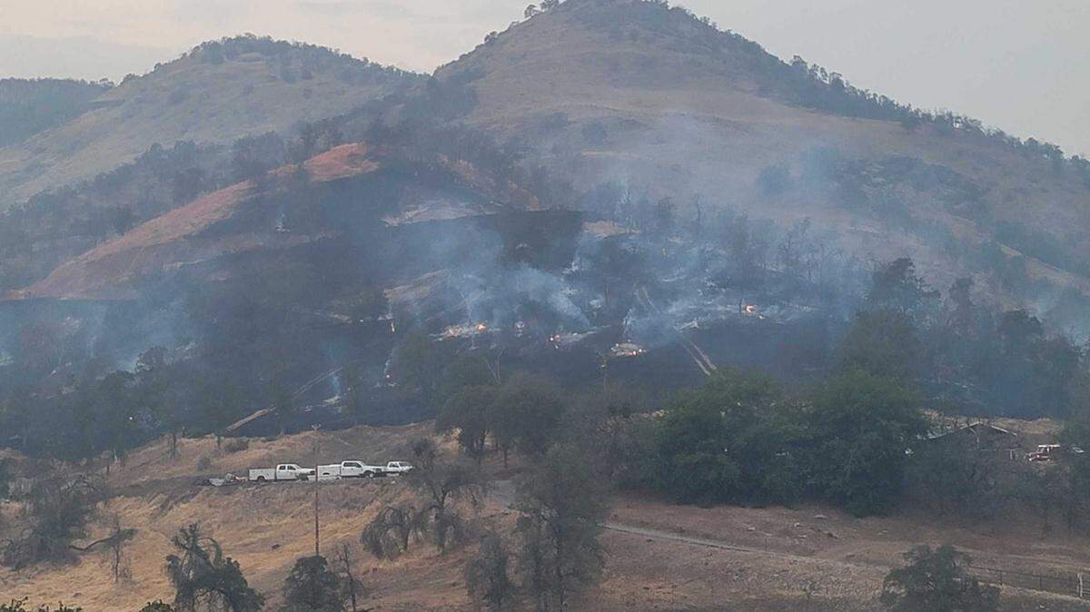 A charred hillside is seen Sunday, Aug. 15, 2021, near Silver Lane in the Squaw Valley area of Fresno County after a fire broke out in dry grass and oak woodland. Nearly 40 acres had burned as of early Sunday night.