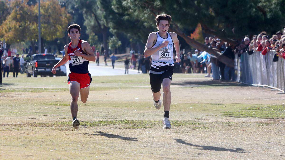 Conor Lott of Clovis North (right) edged Buchanan High’s Luke Sanders in the CIF Central Section Division I boys race cross country race at Woodward Park on Nov. 21, 2024. Lott timed 15:22.8 to Sanders’ 15:23.39. The Buchanan boys won the team title, 47-59, over Clovis East. Clovis North was third.