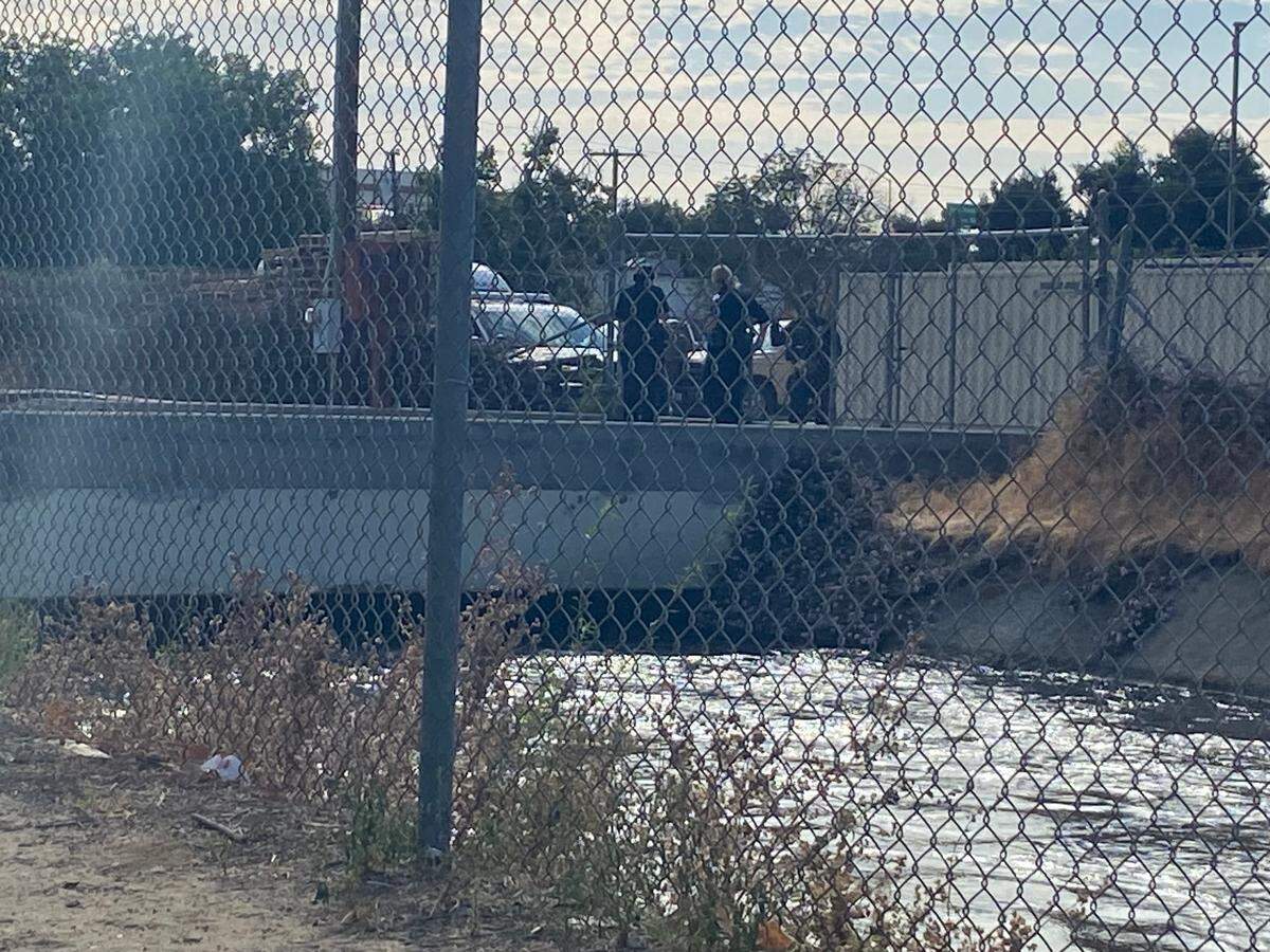 Fresno police investigate a bridge and canal where a body was found between downtown and the Tower District on Monday, June 12, 2023.