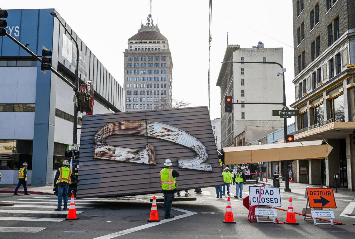 The Guarantee Bank G sign is finally lowered from the Guarantee Bank building in downtown Fresno on Saturday, Feb. 3, 2024. A replica of the historic sign will be installed on the building sometime in mid 2025.