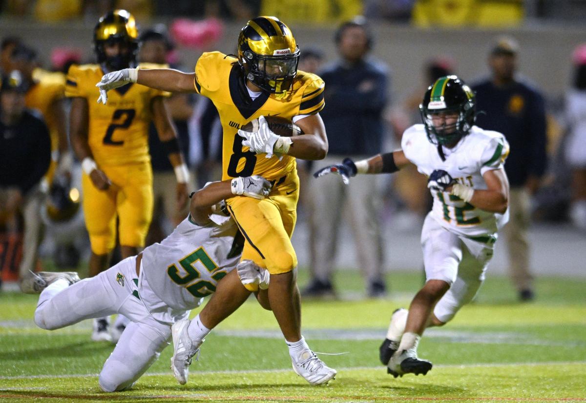 Sunnyside’s Romulan Phetvixay, center, is tackled from behind by Roosevelt’s Fisher Amabisca, left, Friday, Oct. 4, 2024 in Fresno.