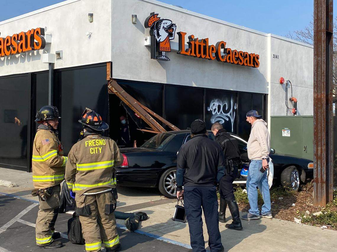 A black sedan collided with the Little Caesers pizza restaurant at Shields and Cedar avenues in Fresno, California, on Wednesday, Feb. 2, 2022.
