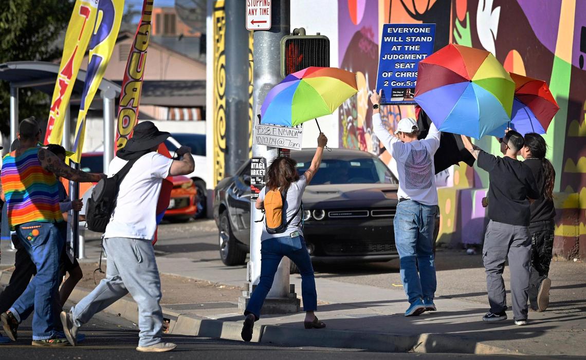 Supporters of a coalition of LGBTQ+ organizations pursue a member of a group from Westboro Baptist Church across the street from Rooseelt High School Monday, Oct. 28, 2024, Fresno.