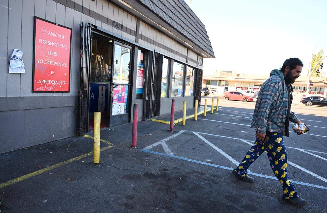 A customer walks out of the Quick Mart at First and Clinton avenues Monday, March 2, 2026 in Fresno. The City of Fresno may take Quick Mart's property through eminent domain, adding the parcel to Radio Park which is currently closed and undergoing a renovation. 