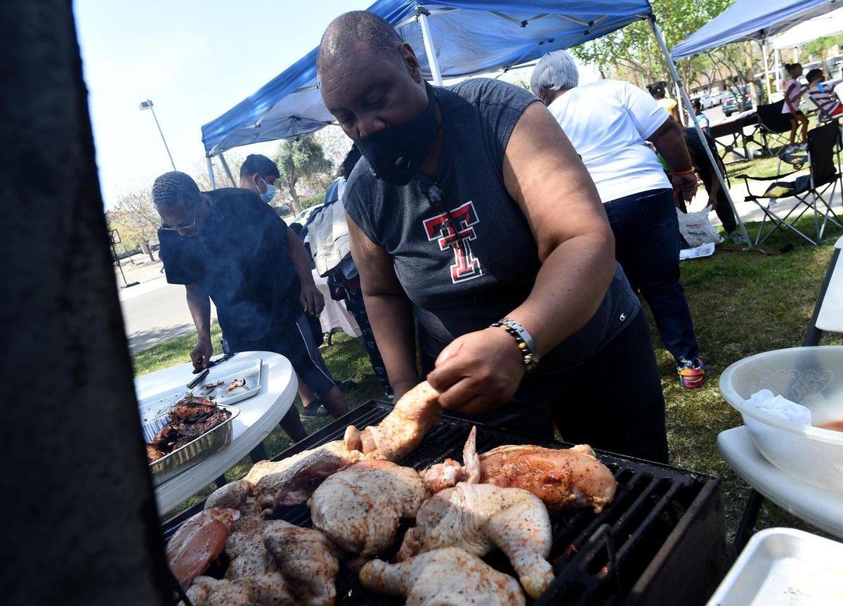 Tony Bullock grills chicken during Resurrection Day Celebration held by The Free AME Ministries, on Saturday, April 3, 2021, in Fresno.