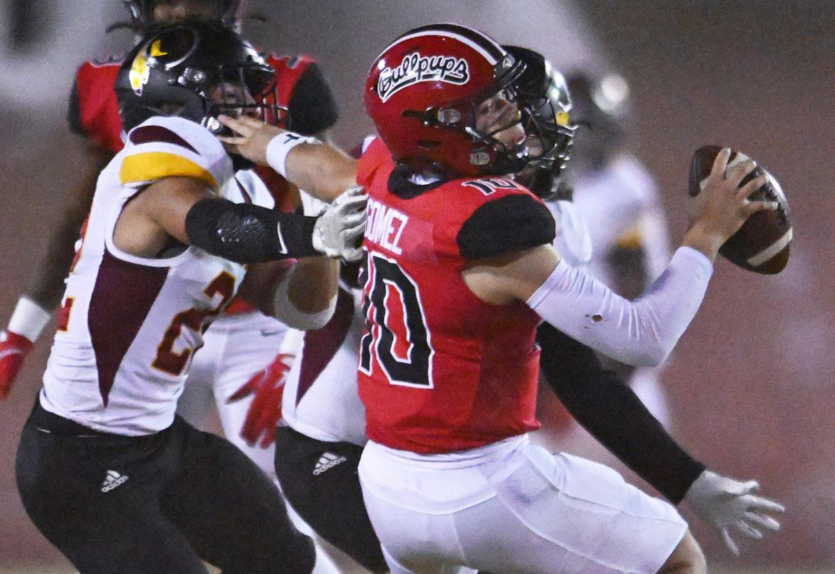 Tulare Union’s Nathan Cordova, left, pressures Hanford quarterback Daniel Gomez, right, in first half action Friday, Oct. 11, 2024 in Hanford.