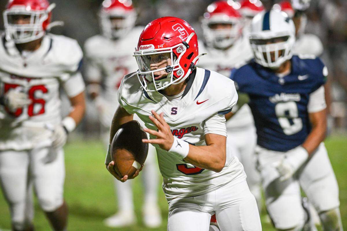 Sanger quarterback Cenzo Calandra turns the corner on a keeper against Clovis East during their game at Lamonica Stadium in Clovis on Friday, Sept. 5, 2025.