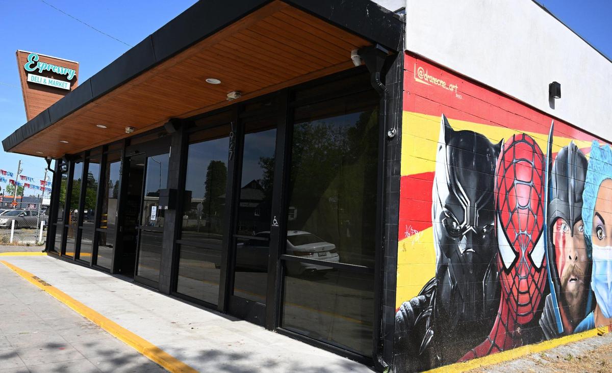 A large mural showing a healthcare worker alongside super heroes is seen outside Akram Mohsin’s new Expressry Deli & Market just walking distance from Community Regional Medical Center. Hospital workers receive a 10% discount on purchases. Photographed Monday, April 14, 2025 in Fresno.