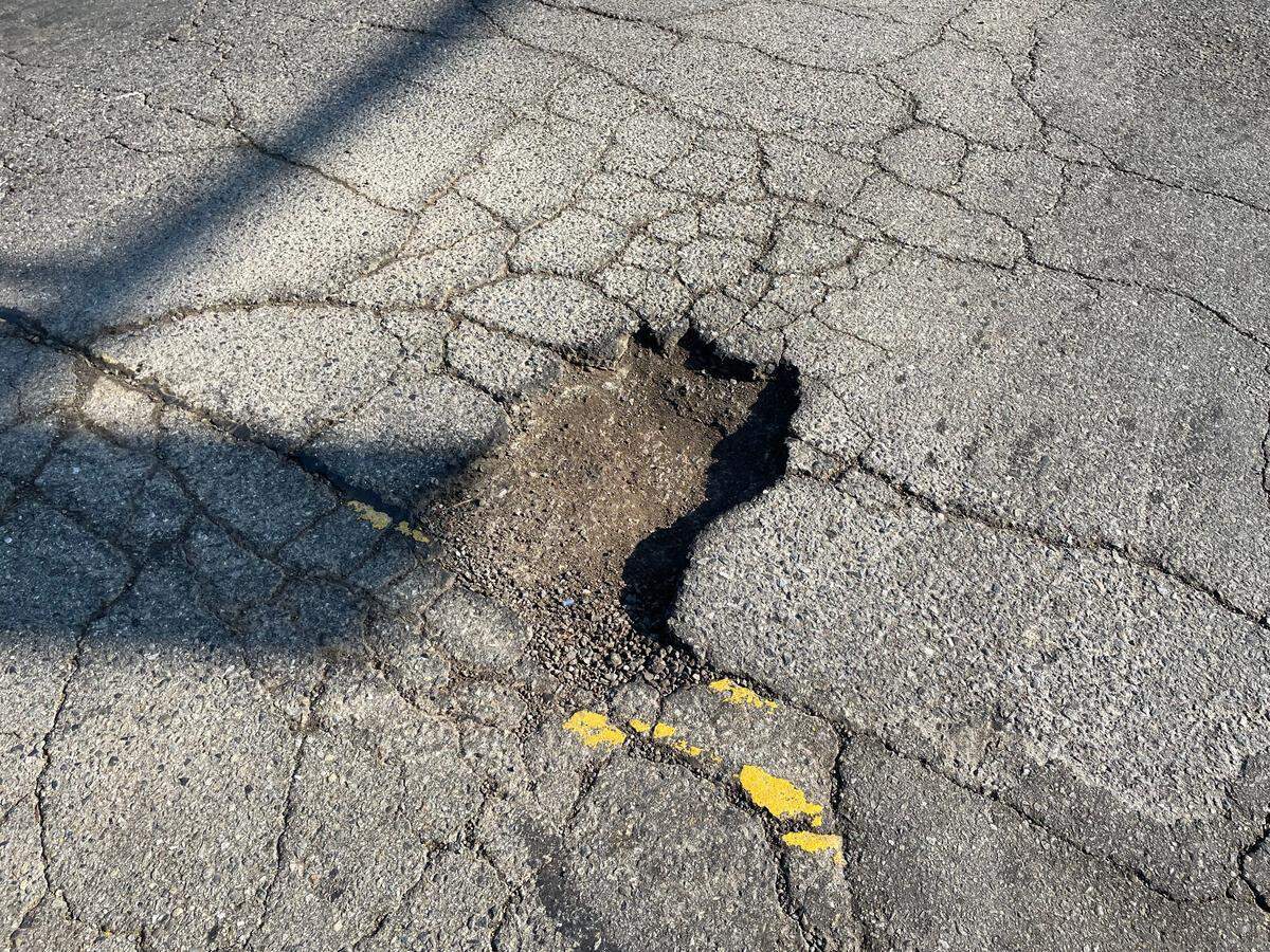 Fresno city officials are targeting large potholes like this one at North Palm and East Clinton avenues, in a 700,000 repair campaign.