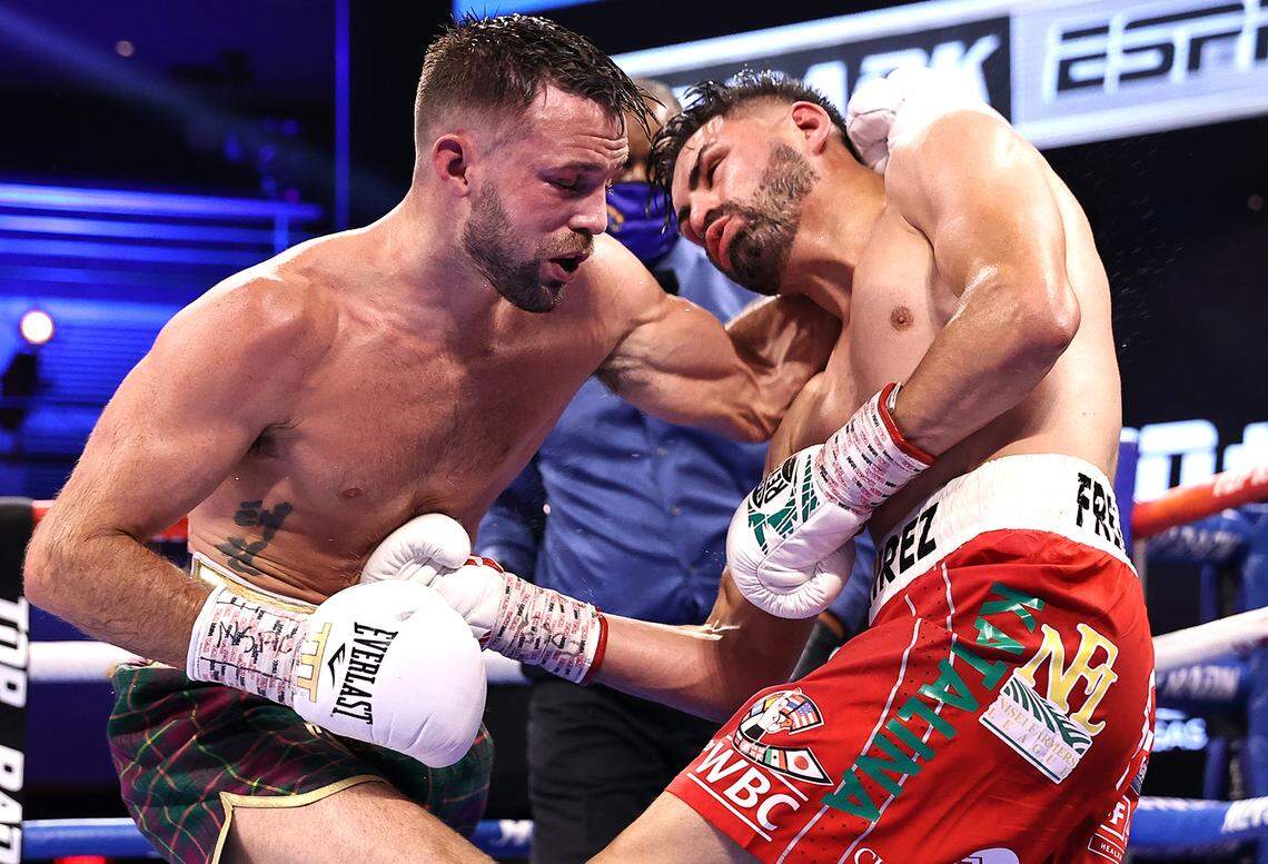 Josh Taylor, left, and Jose Ramirez exchange punches during their fight for the undisputed junior welterweight championship at Virgin Hotels Las Vegas on May 22, 2021, in Las Vegas, Nevada.