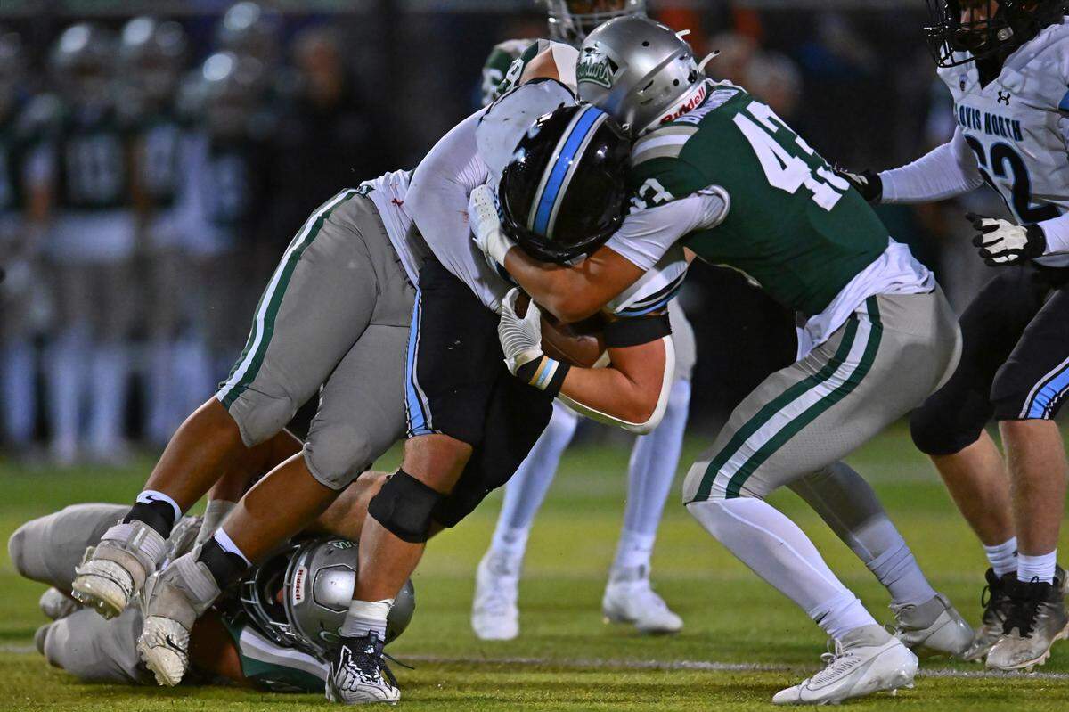 De La Salle’s Niko Bumgartner (43) tackles Clovis North running back McKay Madsen (3) in the second quarter of their NorCal Division I-AA regional championship game at De La Salle High School in Concord, Calif., on Friday, Dec. 1, 2023. De La Salle defeated Clovis North 41-0.