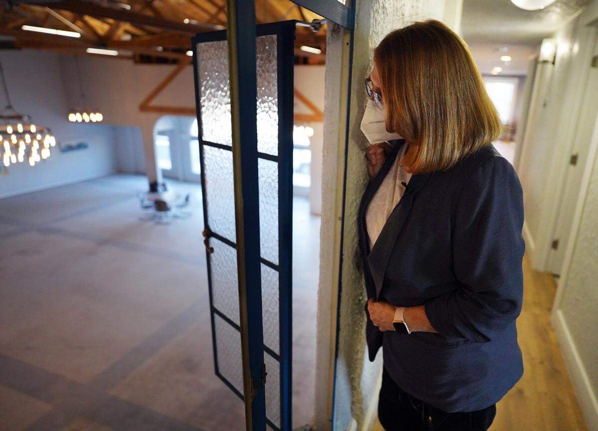 Owner Nora Monaco peers down onto the main floor of a Brewery District building she gives a tour of the building. A whiskey bar has signed a lease with plans to open in the spot at the corner of Fulton and Mono streets Tuesday, Feb. 5, 2021 in downtown Fresno.