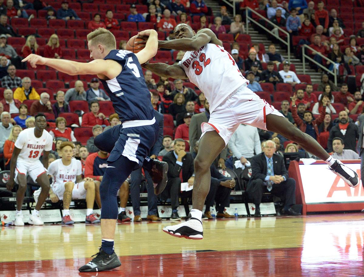 Fresno State’s Nate Grimes, right, gets fouled hard by Utah State’s Sam Merrill while on a fast break during the Bulldogs’ 82-81 loss to the Aggies at the Save Mart Center in Fresno on Tuesday, Feb. 5, 2019.