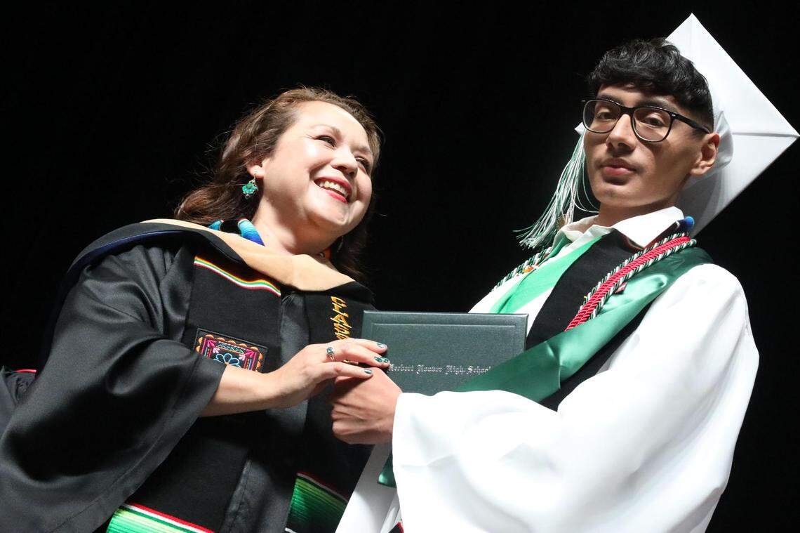 2023 Senior Class President Joseph Aquino gets his diploma from school board member Claudia Cazares during the Hoover High graduation ceremony held at the Save Mart Center on June 6, 2023.