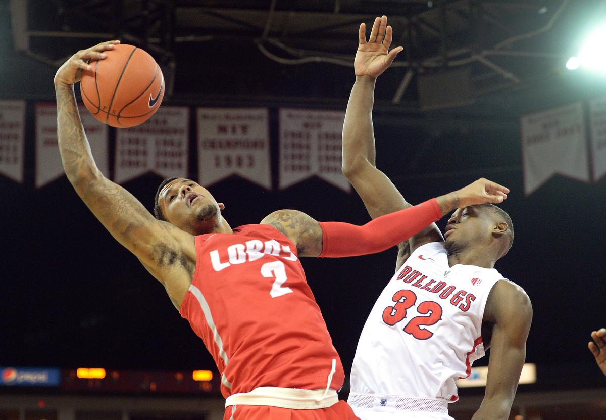 New Mexico’s Vance Jackson, left, and Fresno State’s Nate Grimes scramble for a rebound during the Bulldogs’ 82-70 victory at the Save Mart Center in Fresno on Saturday, Feb. 2, 2019.