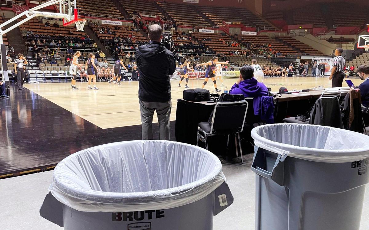 Two trash cans have been placed where rain was leaking from Selland Aena’s roof at the CIF Central Section basketball championships Friday, Feb. 24, 2023 in Fresno.