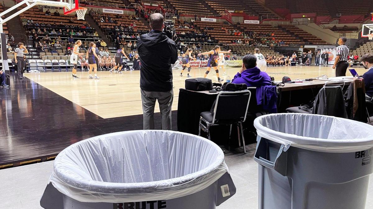 Two trash cans have been placed where rain was leaking from Selland Aena’s roof at the CIF Central Section basketball championships Friday, Feb. 24, 2023 in Fresno.