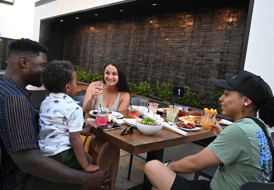A waterfall cascades across the back wall of the patio at The Third Place Global Eatery in Clovis.