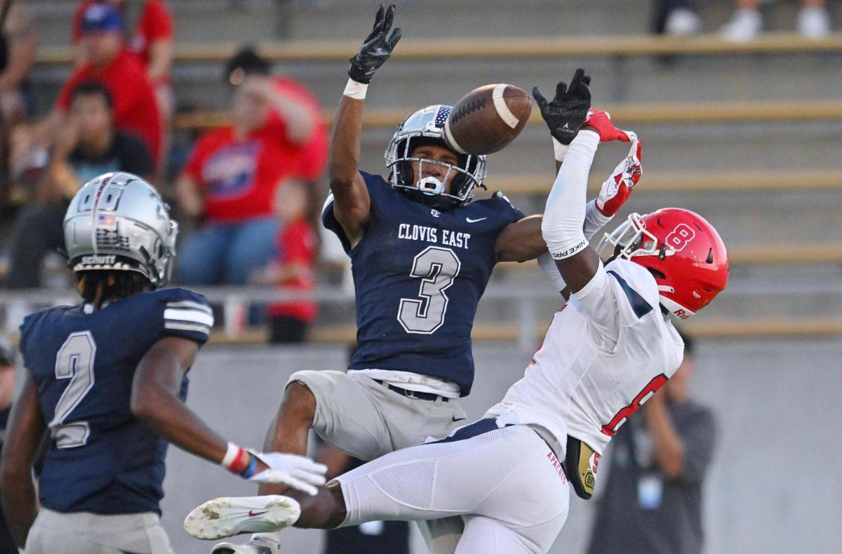 Clovis East’s Landon Nesbitt, left, breaks up a pass intended for Sanger’s Bryson Baker, right, in the Silver Spear trophy game Thursday, Aug. 31, 2023 in Clovis. Clovis East won 42-21.