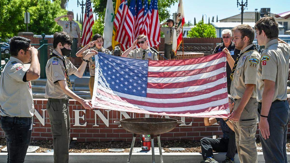 Members of Boy Scouts Troop 257 of Clovis conduct a flag retirement ceremony following a Flag Day ceremony at Centennial Plaza in Clovis on Tuesday, June 14, 2022.