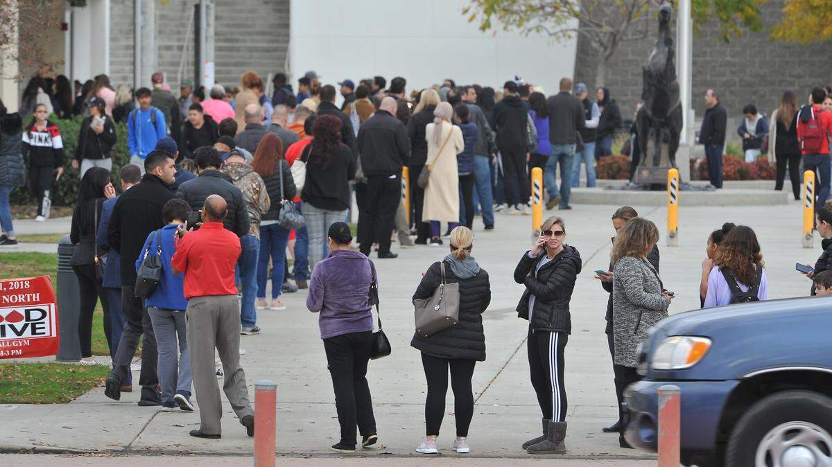 Parents line up to check their children out of school at Clovis North on Tuesday morning, Dec. 11, 2018 after the high school was put on a facility alert due to a threat made to five students on social media.