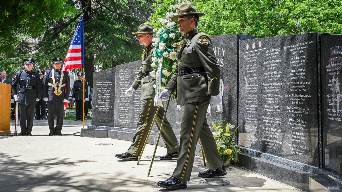 Fresno County Sheriff’s Department deputies leave a wreath at the Fresno County Peace Officers Memorial in Courthouse Park during the Fresno Peace Officer memorial ceremony honoring fallen law enforcement, on Thursday, May 5, 2022.