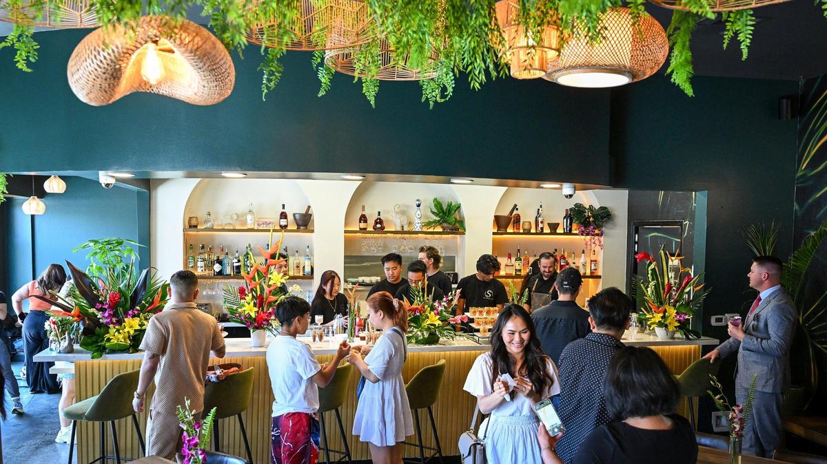 Guests check out the dining room while partaking in drinks and appetizers during the grand opening event for Satay Thai Kitchen and Bar in north Fresno on Thursday, May 8, 2025.