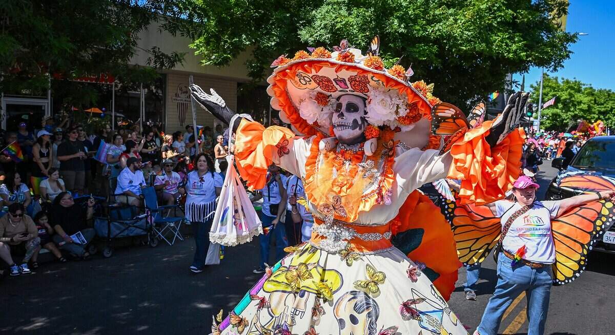 A parade participant dressed in a calacas costume walks with others from the Consulate of Mexico in Fresno and local community partners during the annual Fresno Rainbow Pride Parade and Festival in the Tower District on Saturday, June 6, 2026.