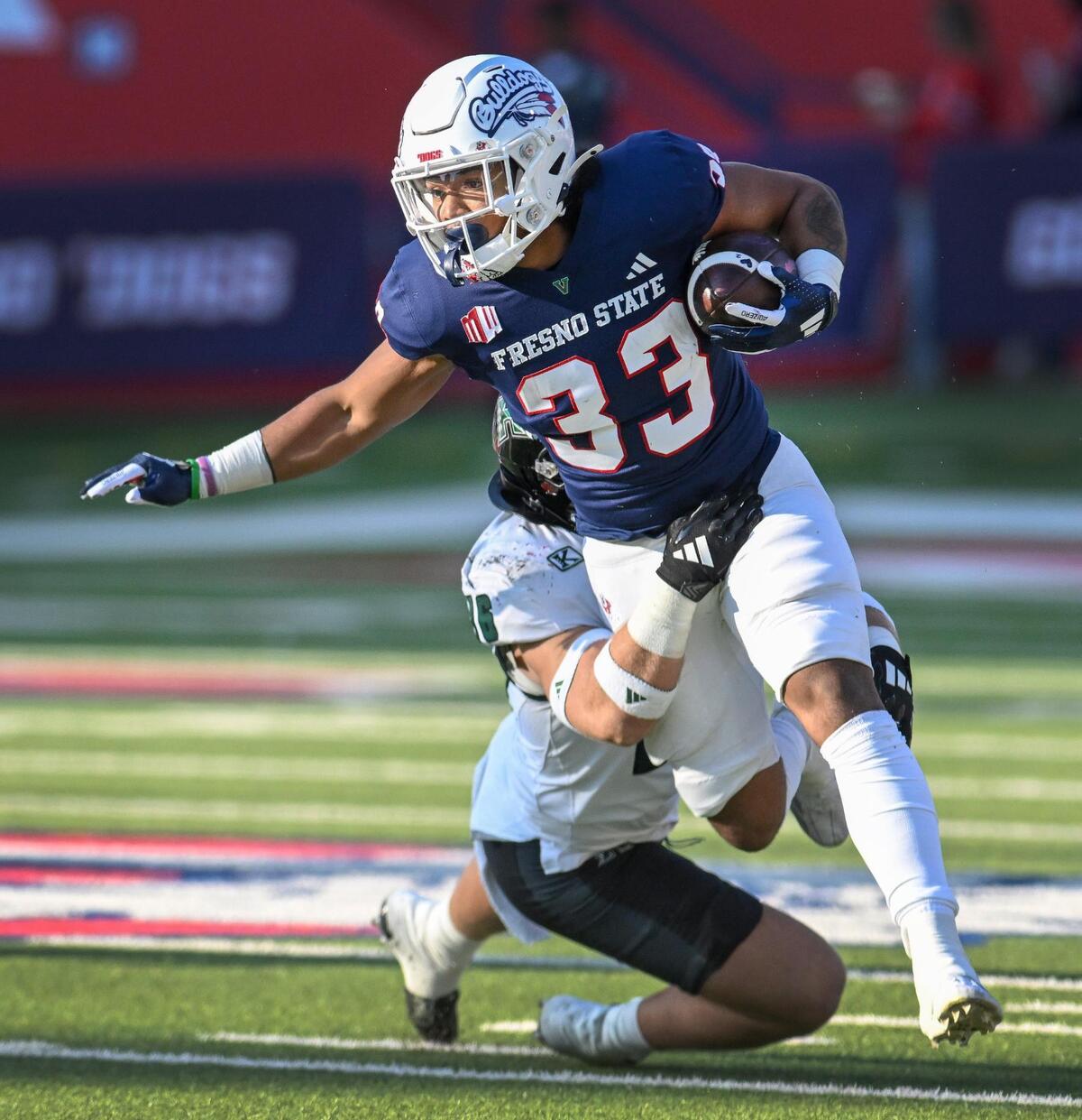 Fresno State’s Elijah Gilliam tries to turn upfield while getting pulled down by Hawaii’s Logan Taylor during the first half of their game at Valley Children’s Stadium in Fresno on Saturday, Nov. 2, 2024.