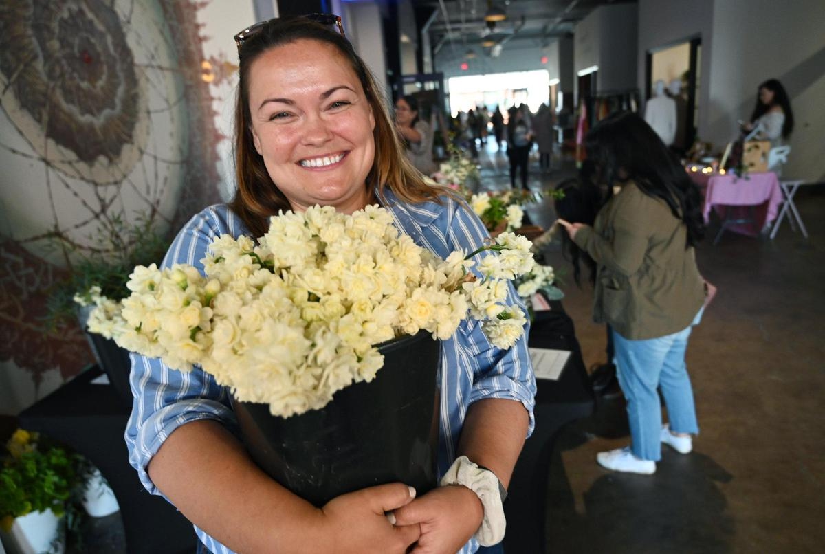 Owner Danielle Fischer stands at the first Flower Market event, held inside the Sun Stereo Warehouse in downtown Fresno’s Brewery District Saturday morning, March 18, 2023. Fischer said the Sun Stereo Warehouse location will be the hub for the market, held now through October, with additional locations including Clovis and Merced offered later.