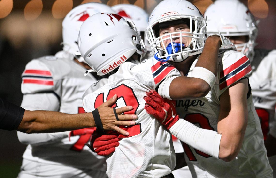 Sanger’s Cody Coles, center right, and others celebrate Kayden Mcgrew’s touchdown, center left, against San Joaquin Memorial Friday, Nov. 1, 2024 in Fresno. Sanger beat Memorial 59-21.