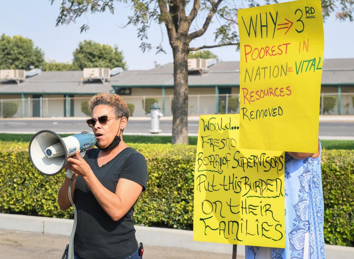 West Fresno resident June Stanfield speaks during a protest against the moving of social services to Clovis outside the Department of Social Services building in west Fresno, on Wednesday, Sept. 15, 2021.