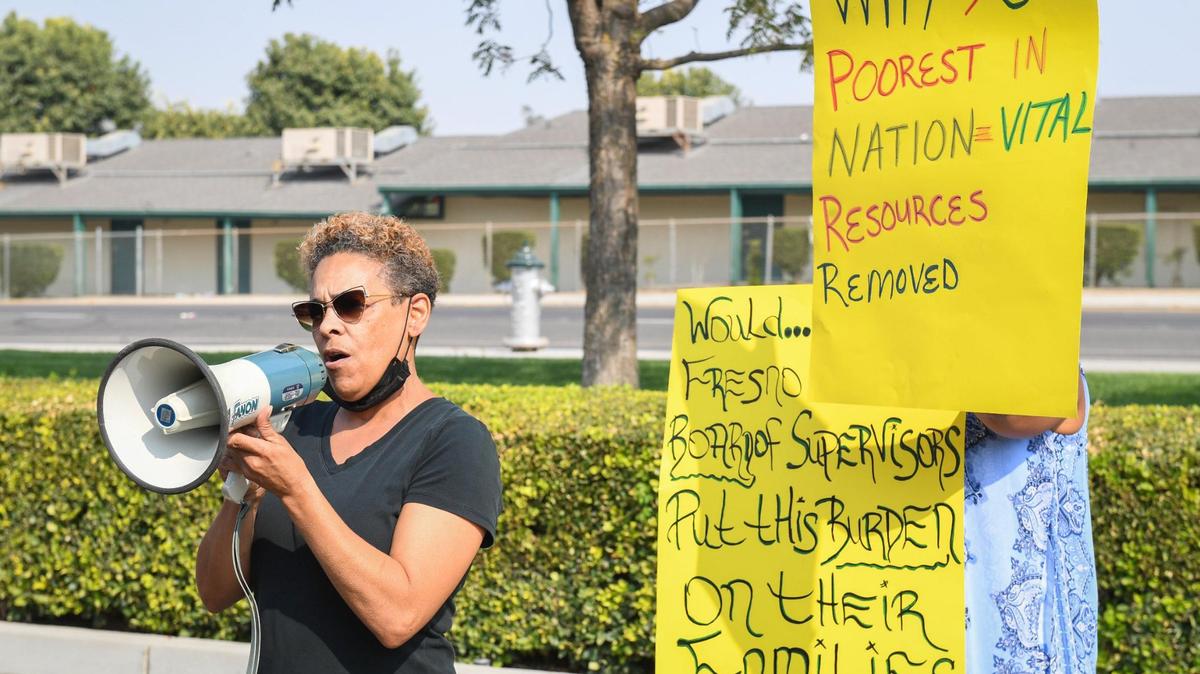 West Fresno resident June Stanfield speaks during a protest against the moving of social services to Clovis outside the Department of Social Services building in west Fresno, on Wednesday, Sept. 15, 2021.