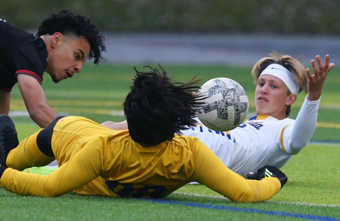McLane’s Daniel Contreras, left, collides with Terra Linda’s Cole Greene, right, and goalkeeper in the CIF Northern California Regional Division III boys soccer championship Saturday, March 4, 2023 in Fresno. Terra Linda won the championship, 2-0.