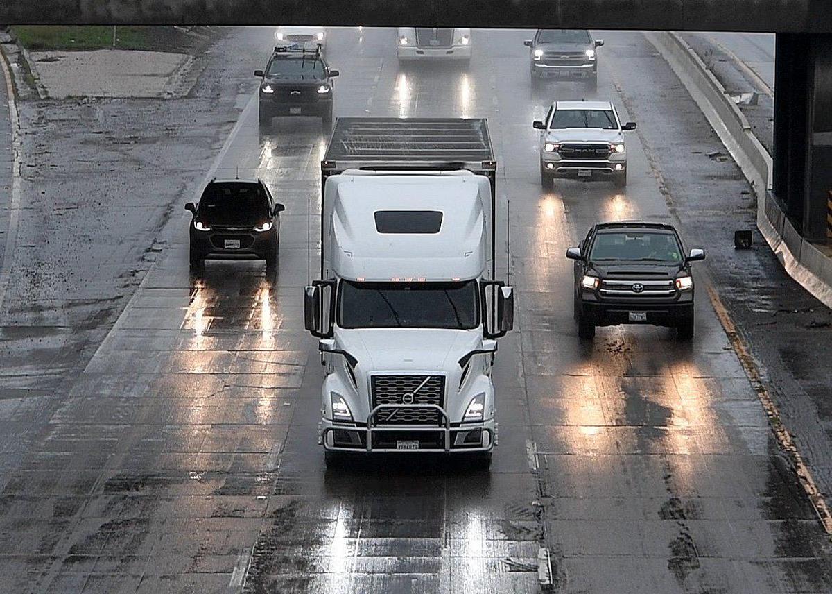 Traffic moves cautiously on a drenched northbound 99 through downtown Fresno, during the storm Tuesday, Dec. 14, 2021.