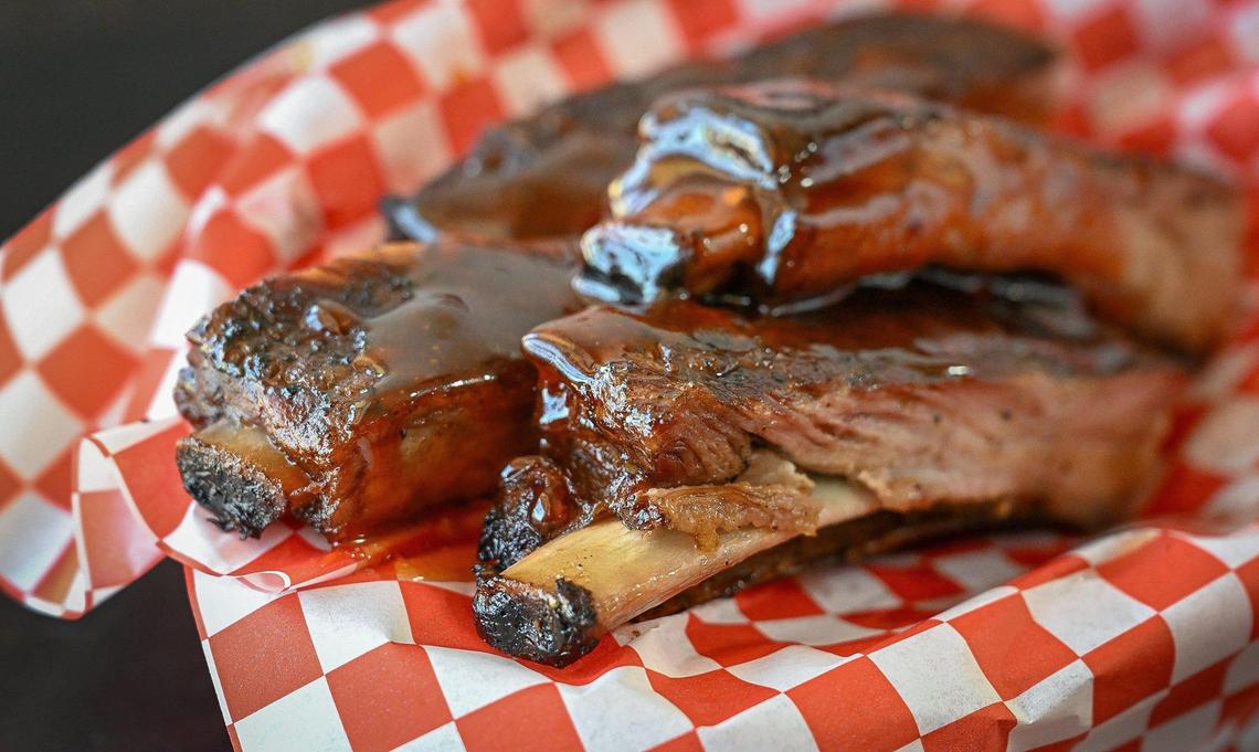Barbecue pork ribs are doused in a homemade sauce at Hogg Pitt BBQ & Catering at its new location on Ashlan and Fresno in Fresno on Monday, June 2, 2025.