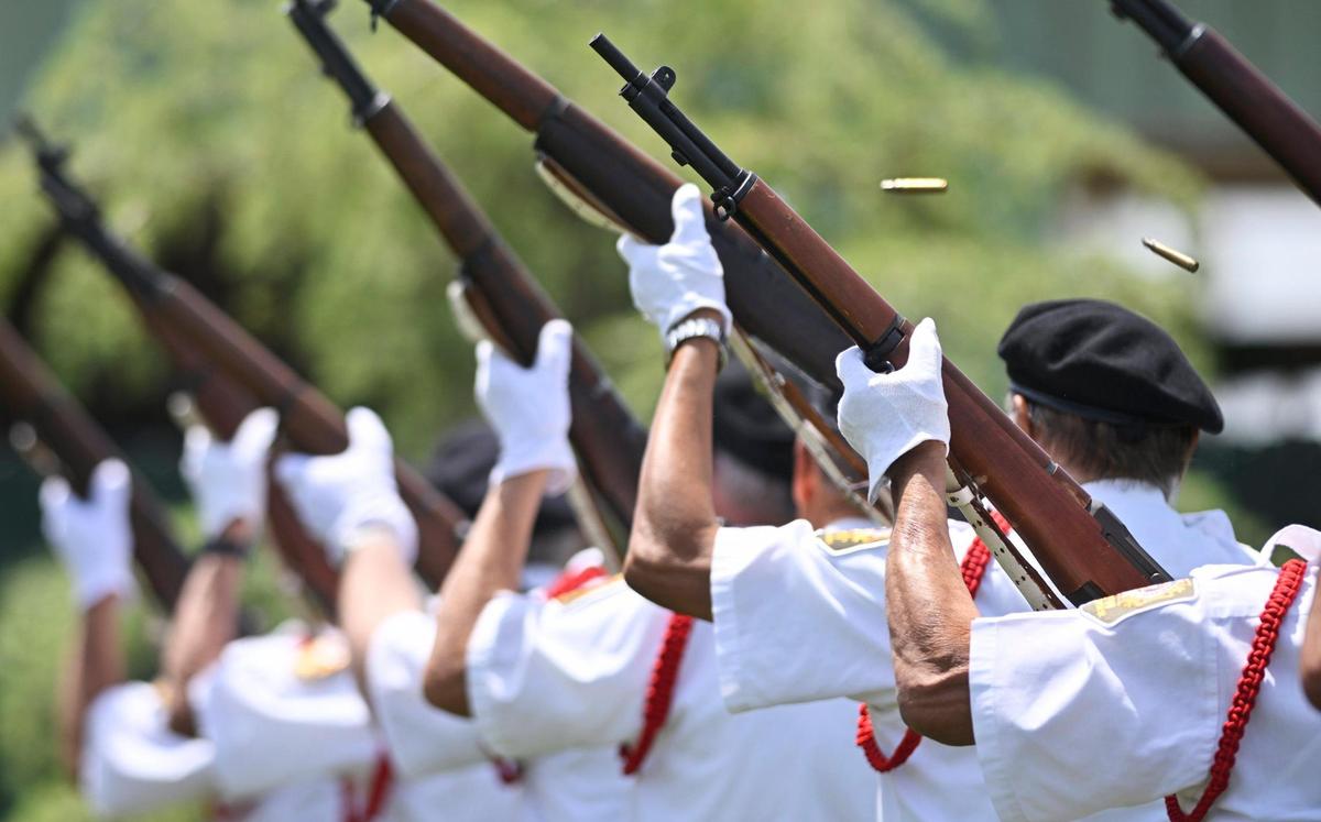 Spent cartridges fly as the VFW Post 8470 Kerman color guard performs a rifle salute at the 60th VFW Memorial Day Service held at Fresno Memorial Gardens Monday, May 29, 2023 in Fresno.
