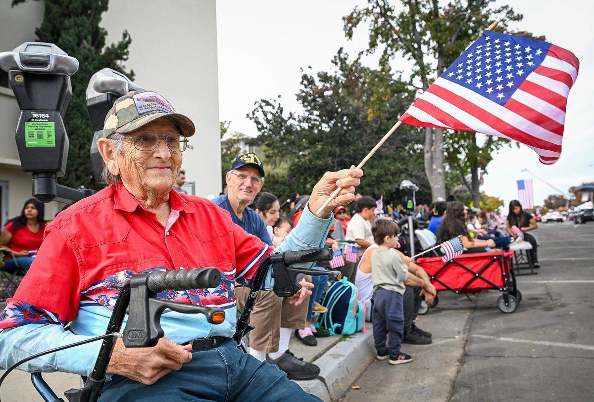 Ernest Shipman, left, and his brother Richard Shipman, who served in the Air Force during the Vietnam conflict, both of Fresno, cheer on participants in the Central Valley Veterans Day Parade in downtown Fresno on Tuesday, Nov. 11, 2025. 